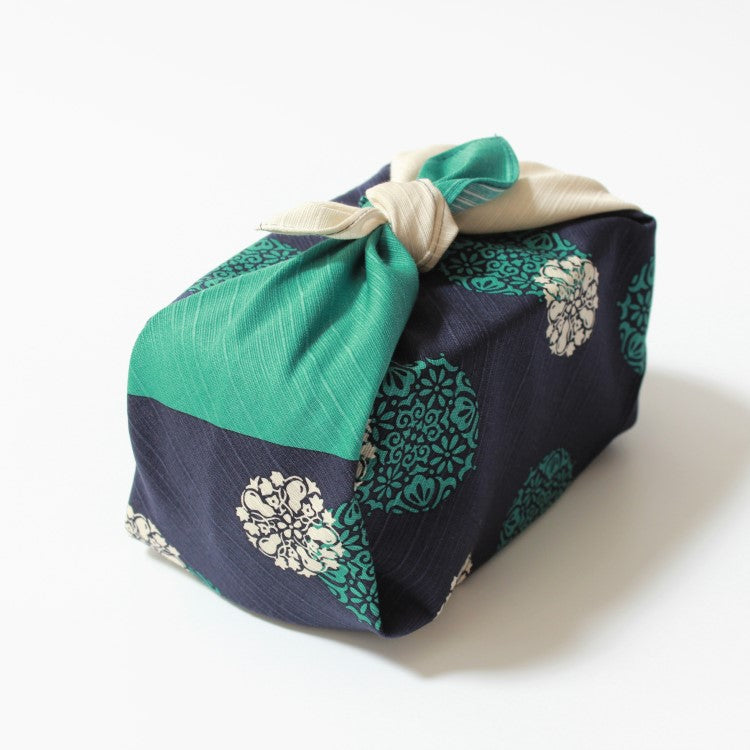 top angled view of bento box wrapped in the Yume Hana Komon furoshiki from Hama Monyo