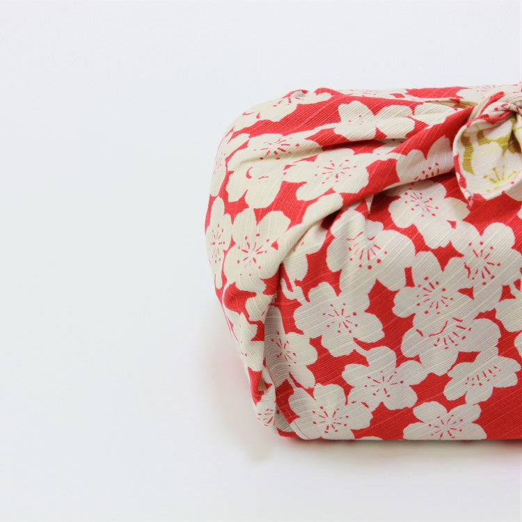 side view of the red side of the isa monyo sakura pink and light green furoshiki