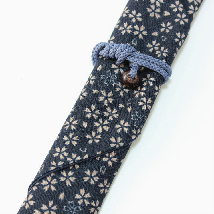 Close up shot showing the string wrapped around a chopsticks case