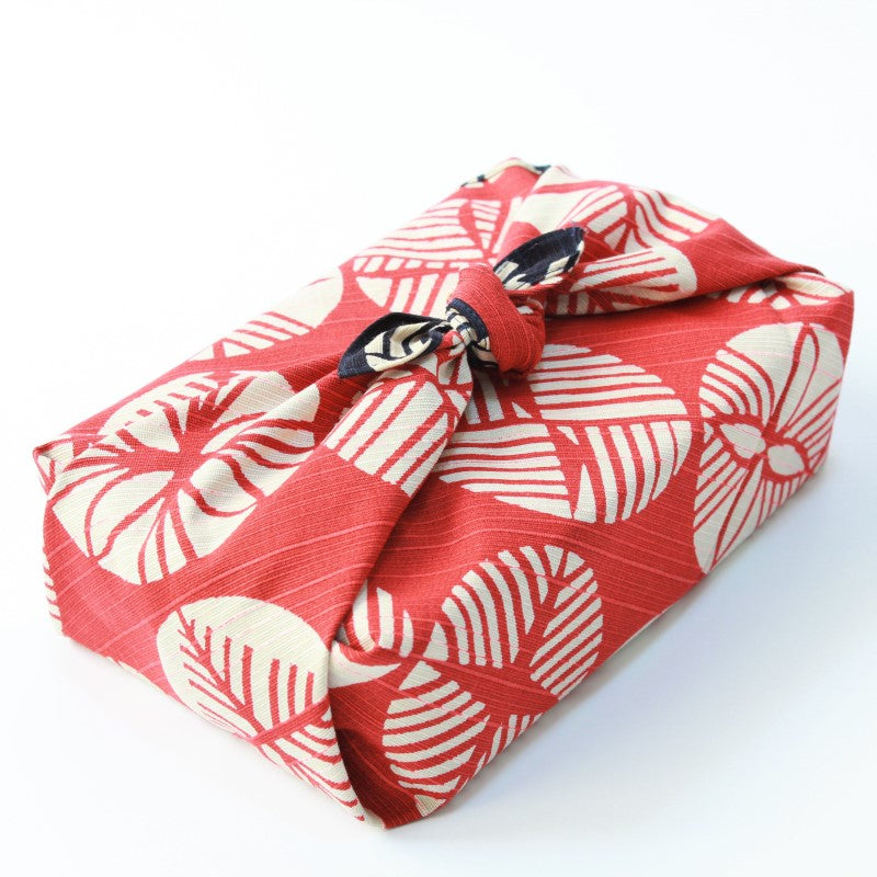 Bento box wrapped with the red side of the isa monyo pine pattern furoshiki