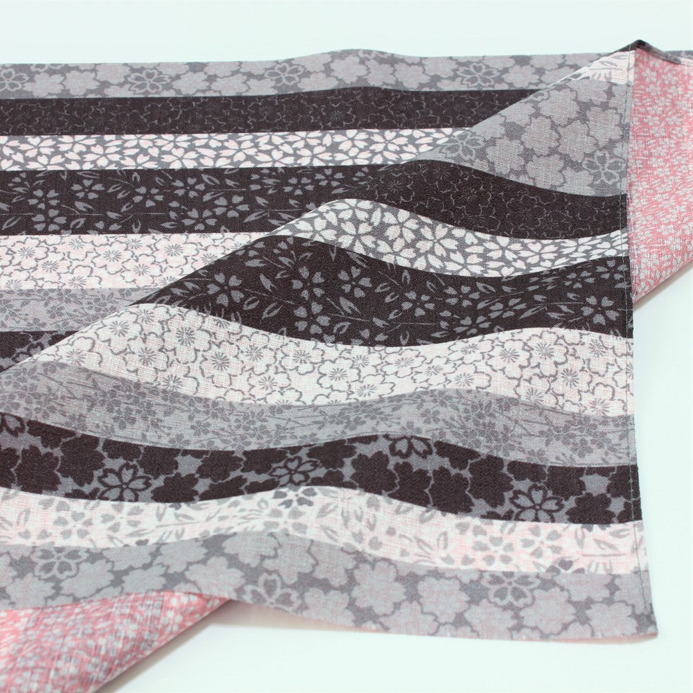 One side shows stripes of different coloured background with sakura flowers.