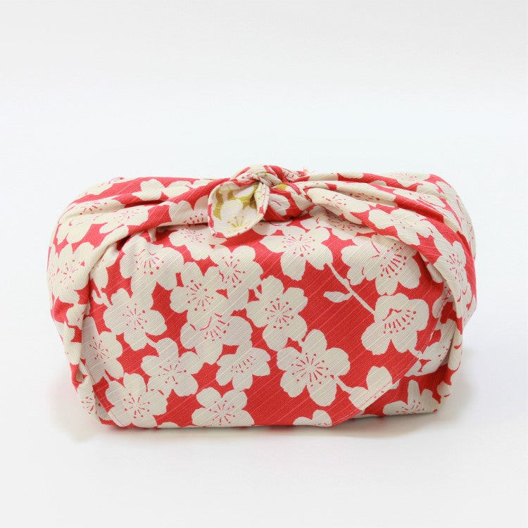 zoomed out side view of a bento box wrapped in japanese wrapping cloth