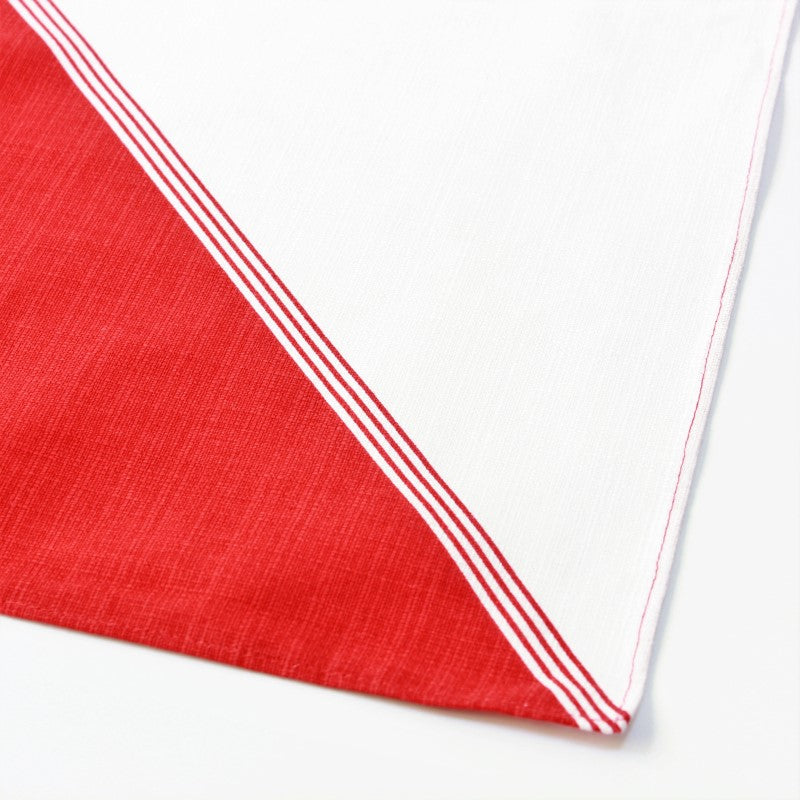 Unwrapped furoshiki showing diagonal line separating red and white colours of this furoshiki