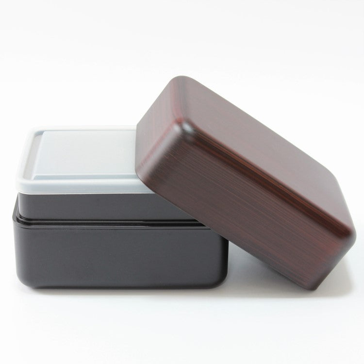 Side view of benkei bento box showing lid leaning against the 2 layers