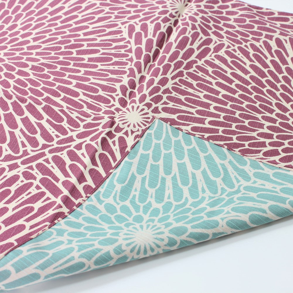 Chrysanthemum flowers resembling fireworks, on a purple and sage blue background in this furoshiki.