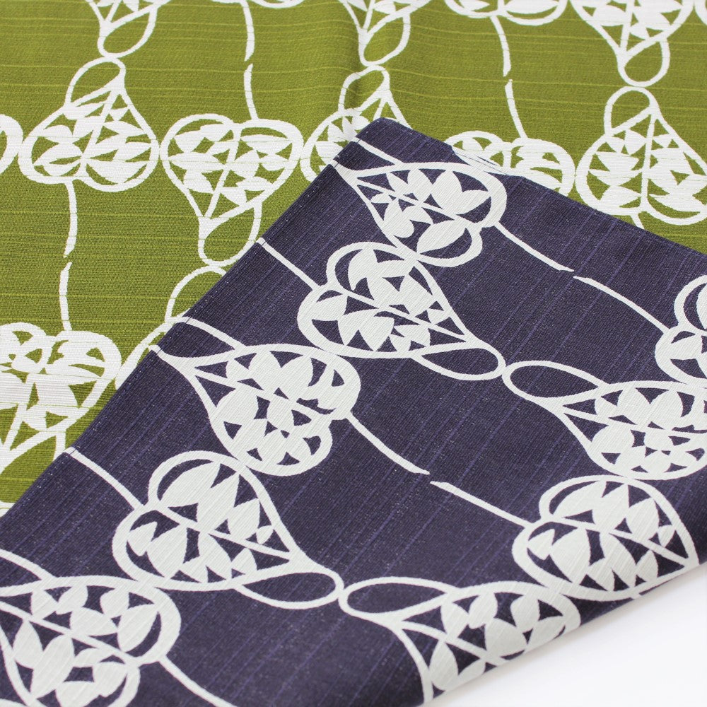 Isa Monyo Heart Vine pattern furoshiki has two sides, one coloured purple and the other with a green background. heart vine patterns are printed on it. 