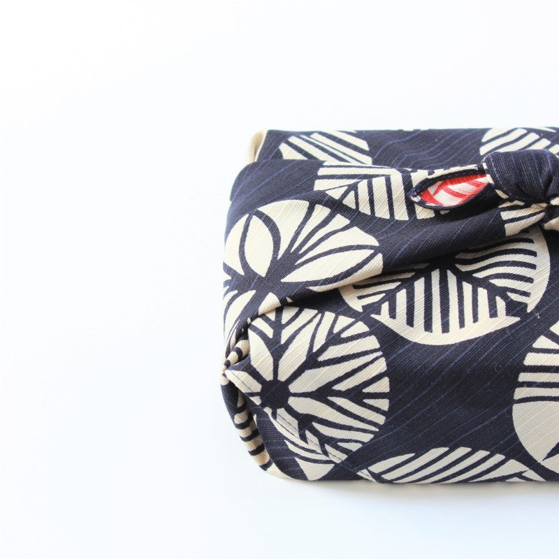 Close up shot of isa monyo furoshiki showing the pine pattern on a navy blue backdrop