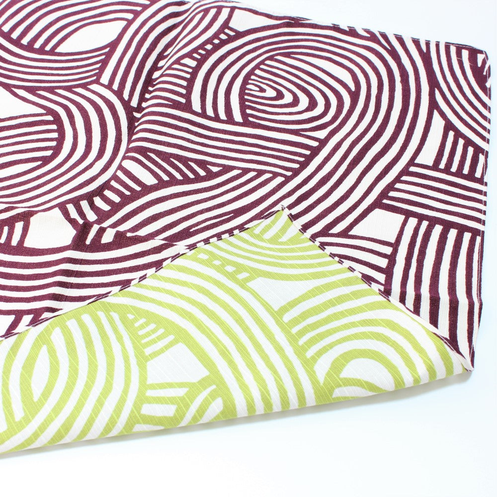 Double sided furoshiki with knot design, showing purple and green sides.