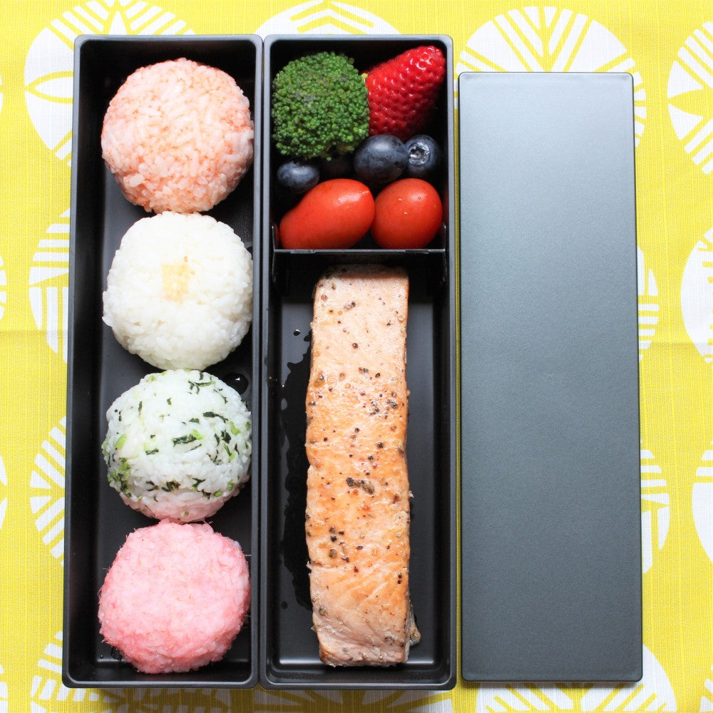Aerial view showing food organized in the metallic black long slim 2 tier bento box