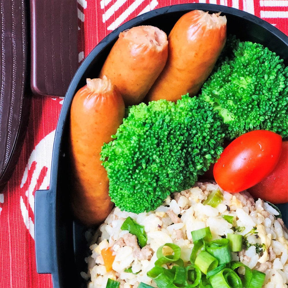 Close up show showing sausages and fried rice in this bento lunch box