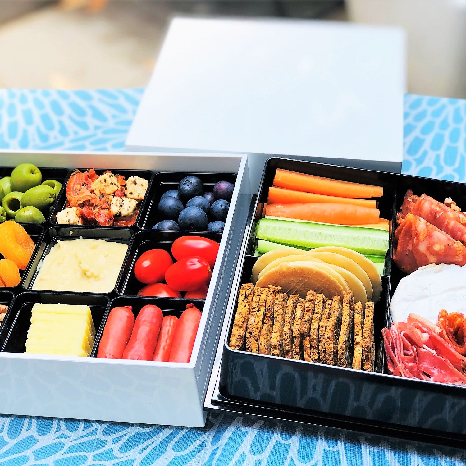 Beautiful charcuterie arrangement in this picnic bento box. 