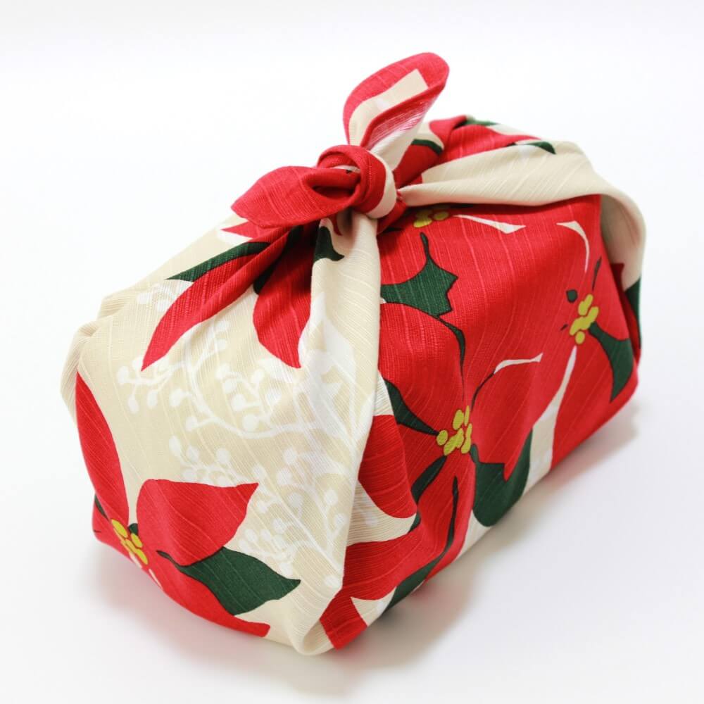 angled bento box shot wrapped in poinsettia furoshiki