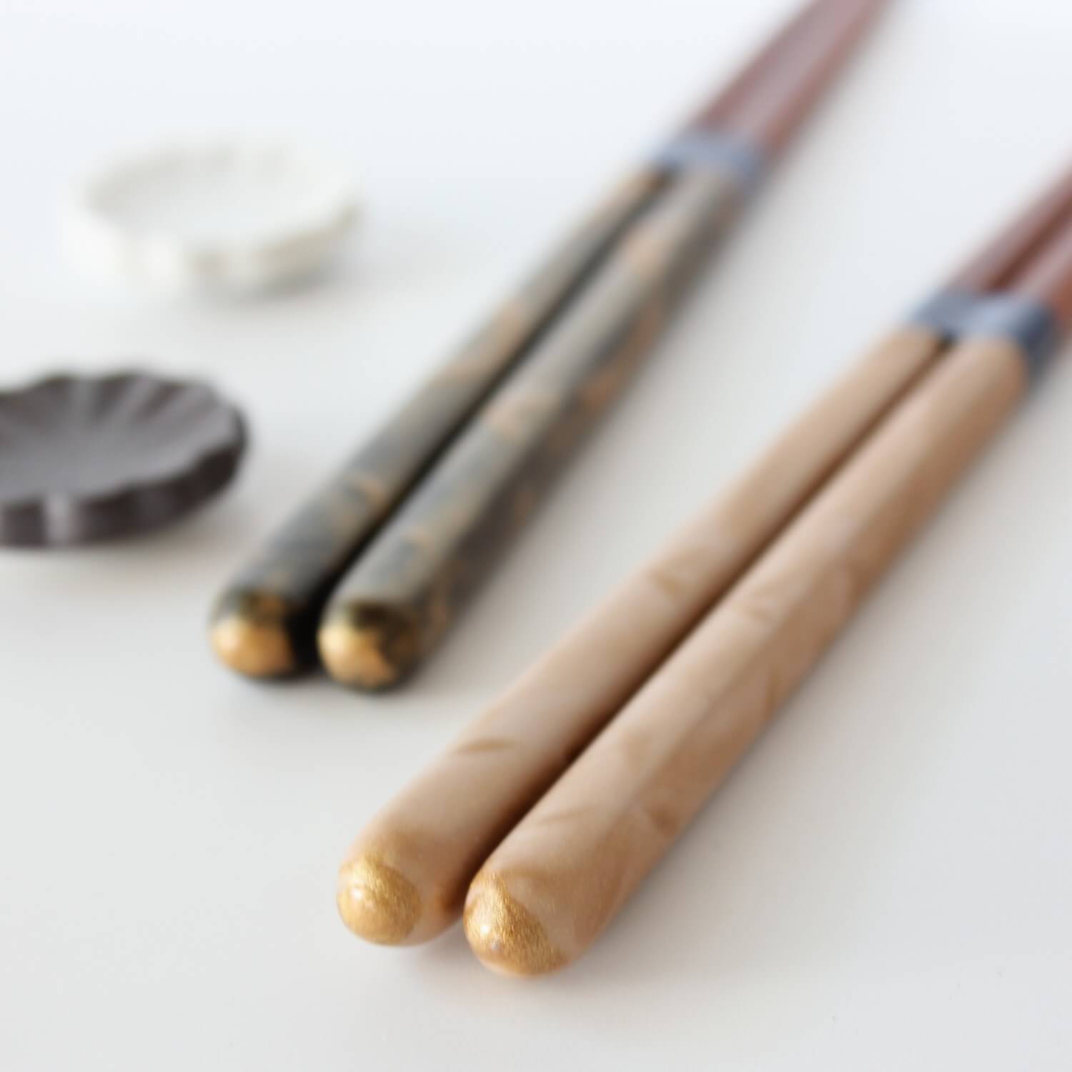 beige gold chopsticks in the foreground
