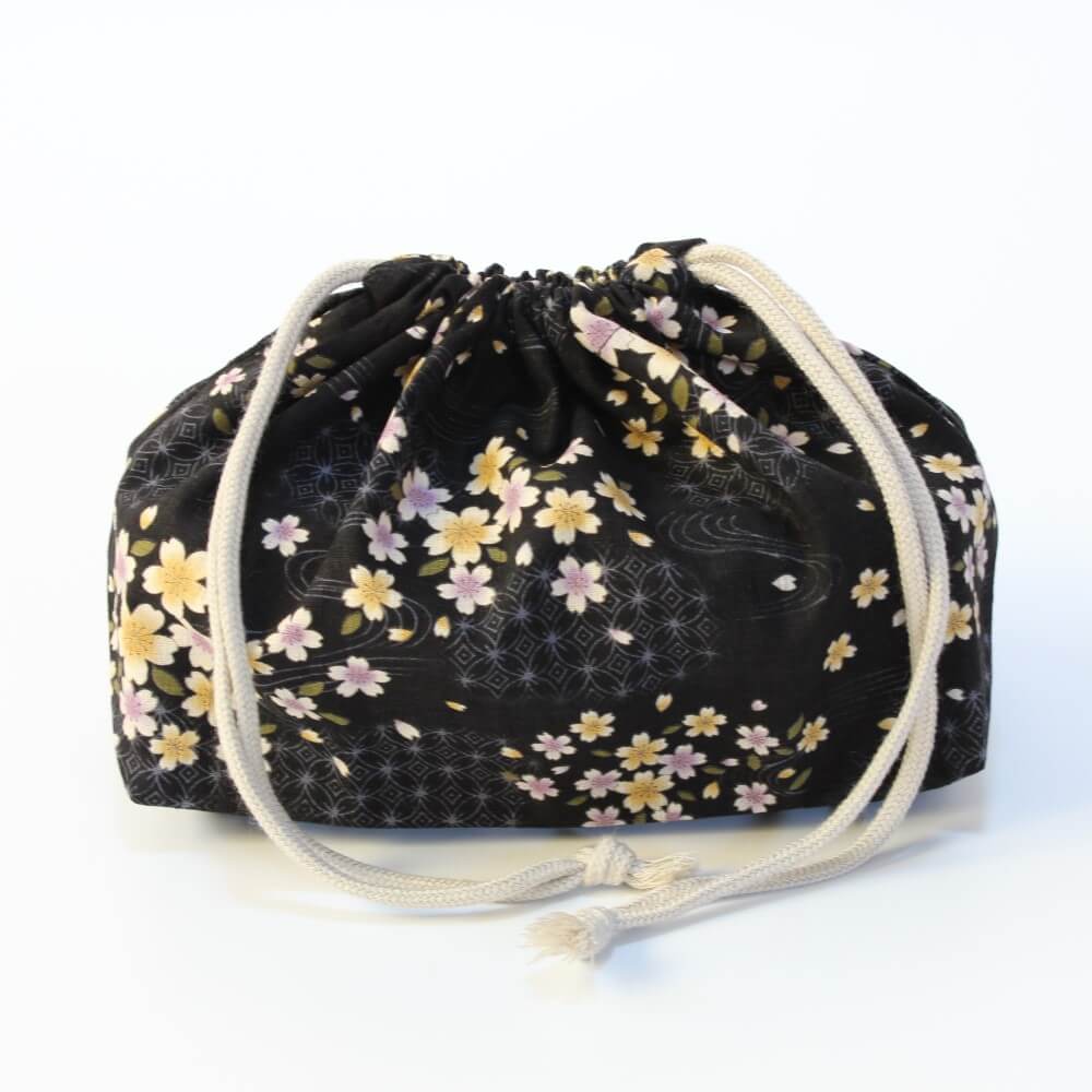 black beneto lunch bag with sakura patterns with bento box inside