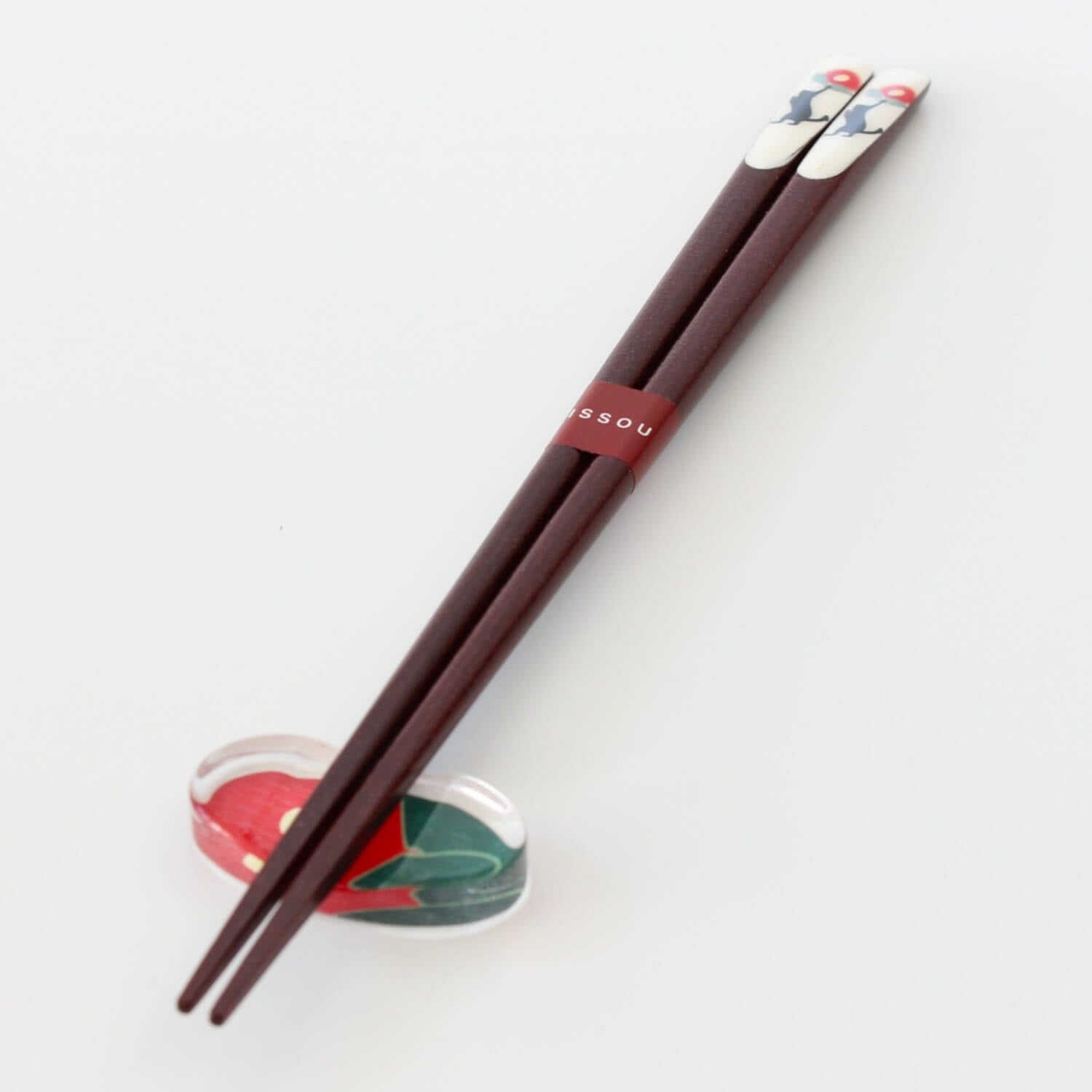 black cat and camellia chopsticks on rest