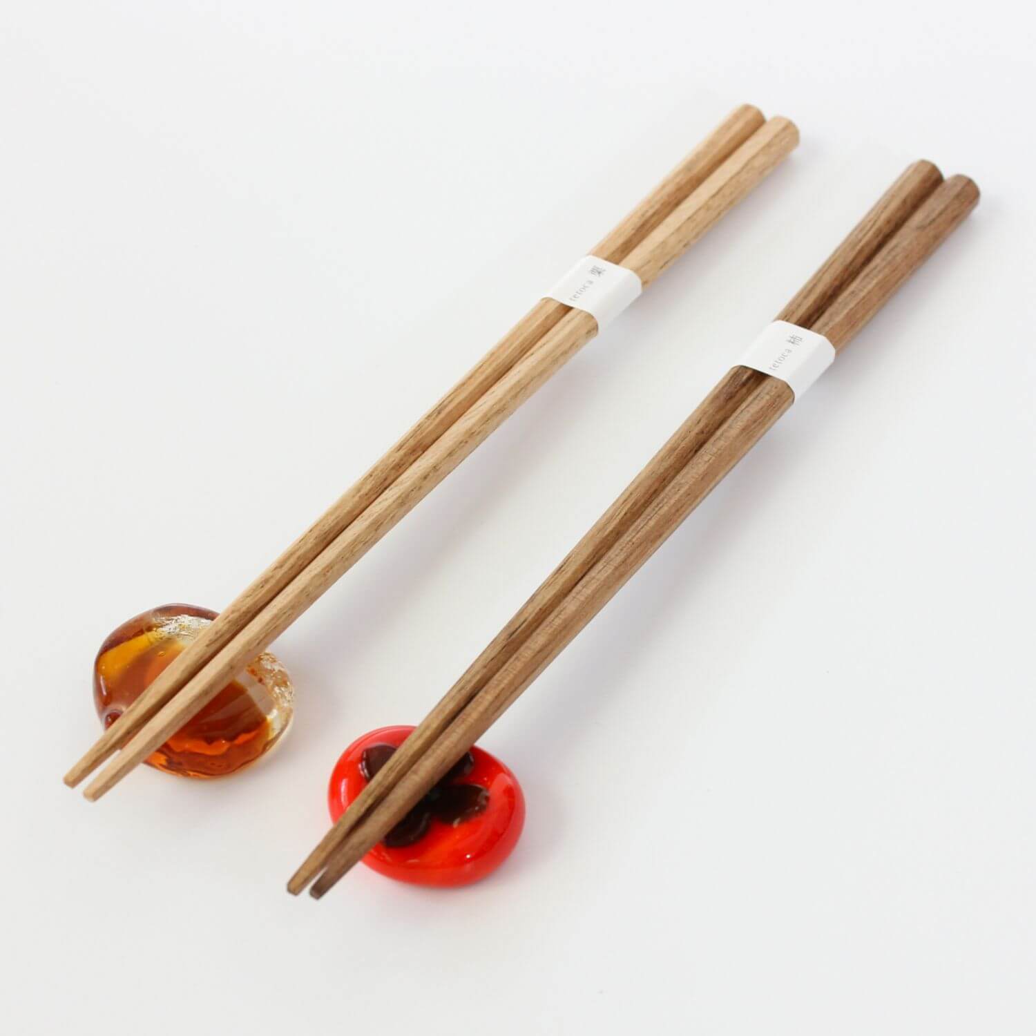 chestnut and persimmon wood chopsticks on rests