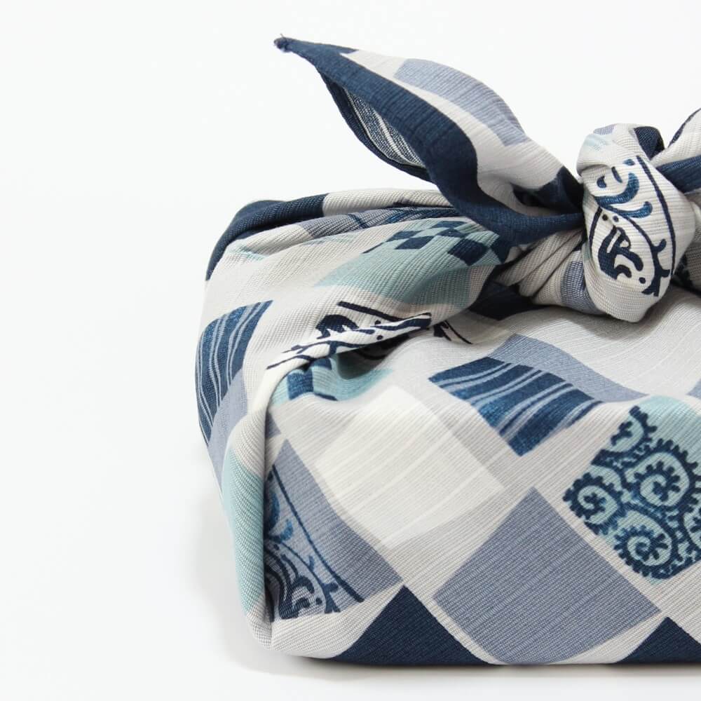 close up bento box wrapped in soba cups furoshiki