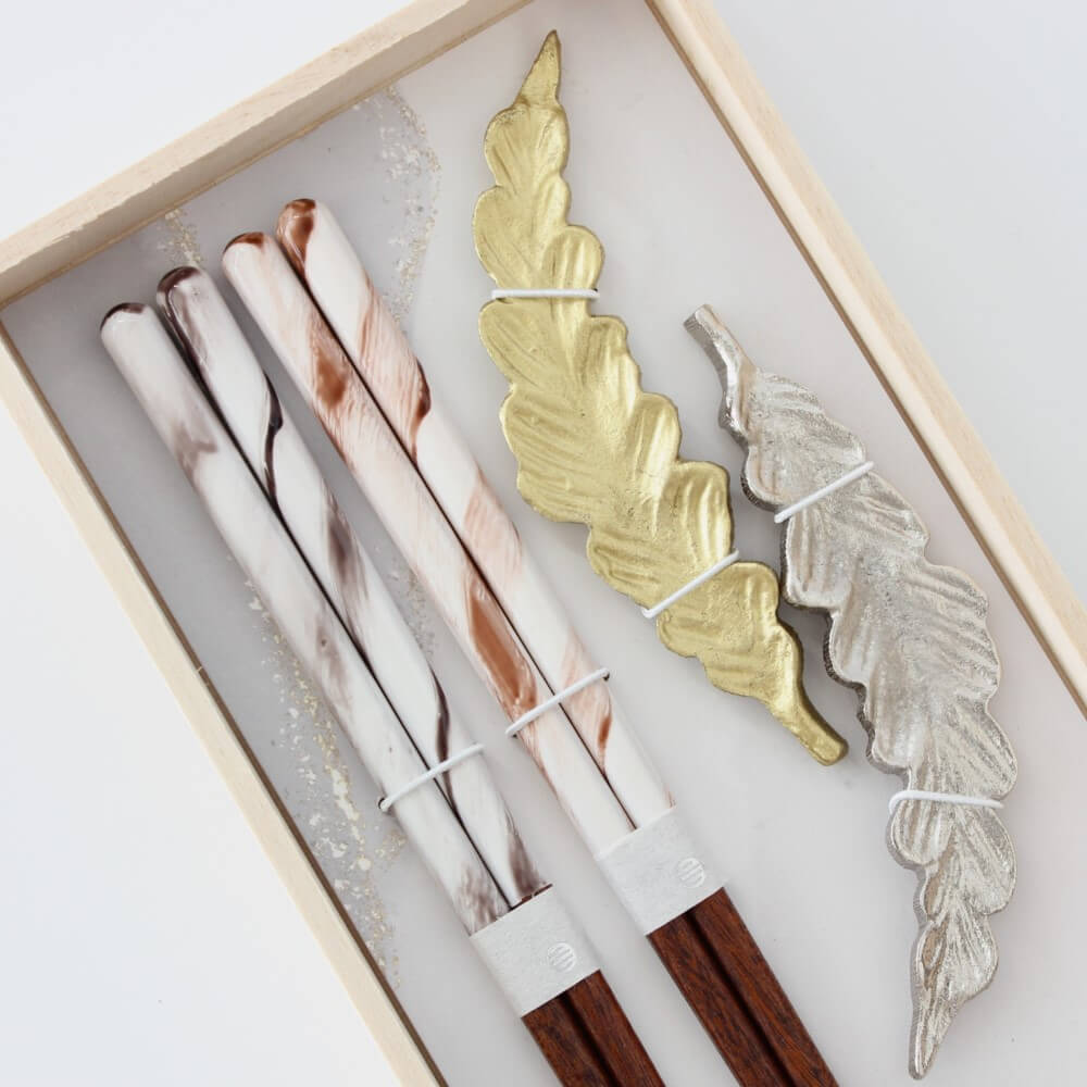 close up chopsticks and rests inside gift box