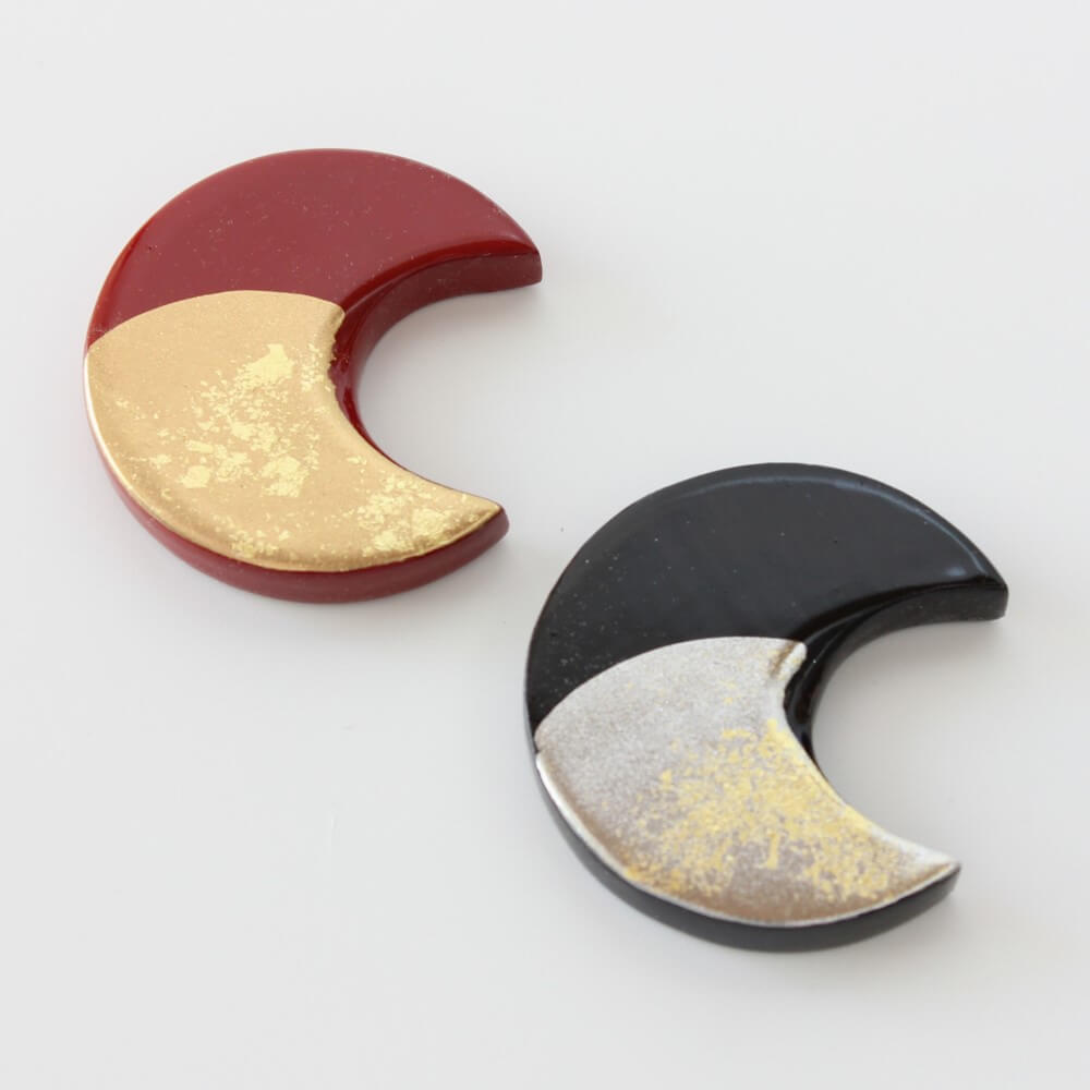 close up crescent moon shaped chopsticks rests