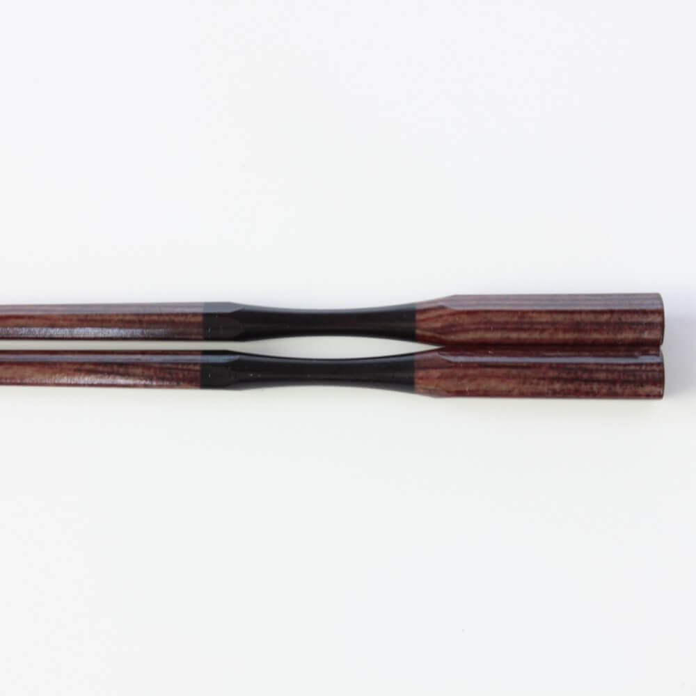 close up of the curved neck antique brown resin chopsticks