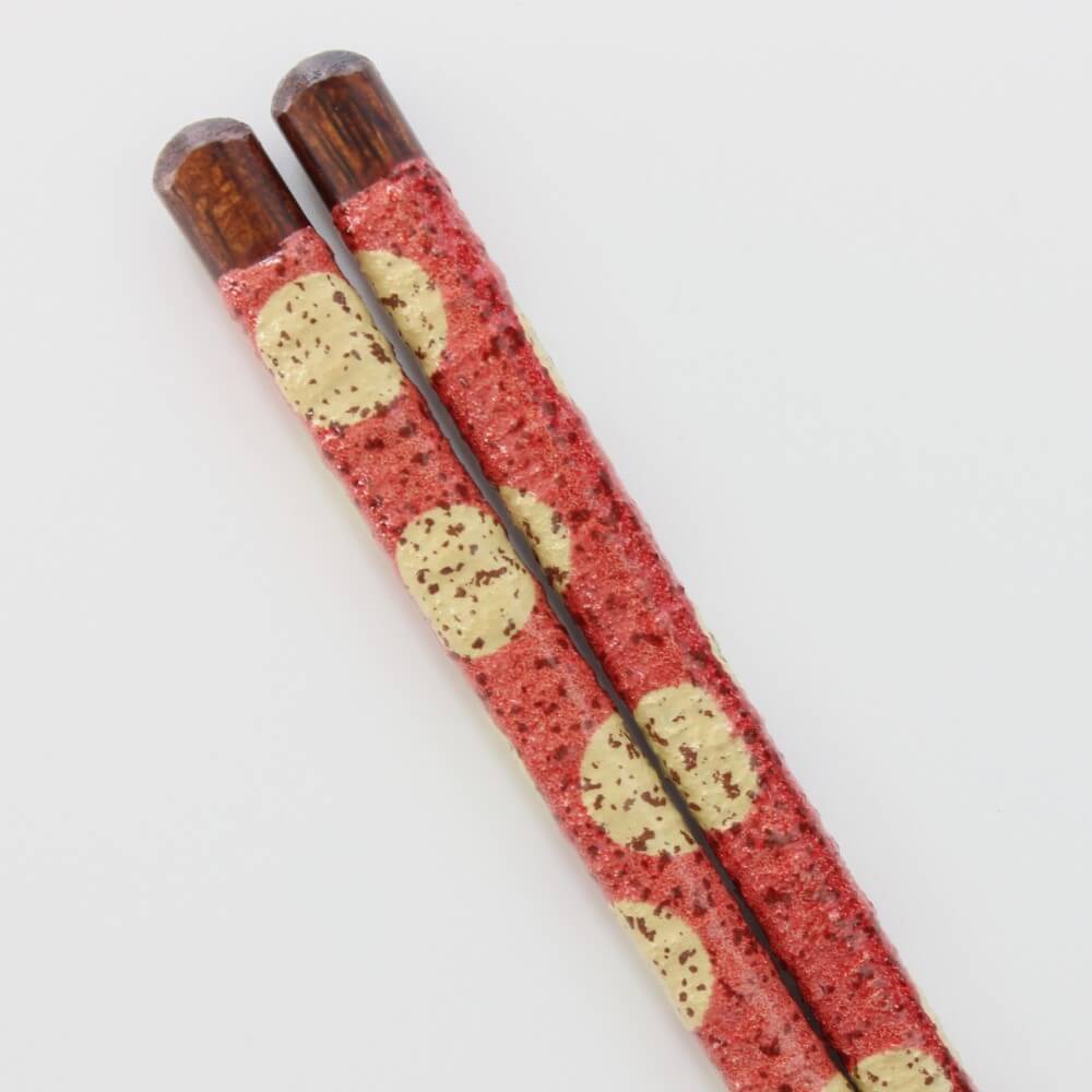 close up of the handle of red mizutama chopsticks yellow polka dots