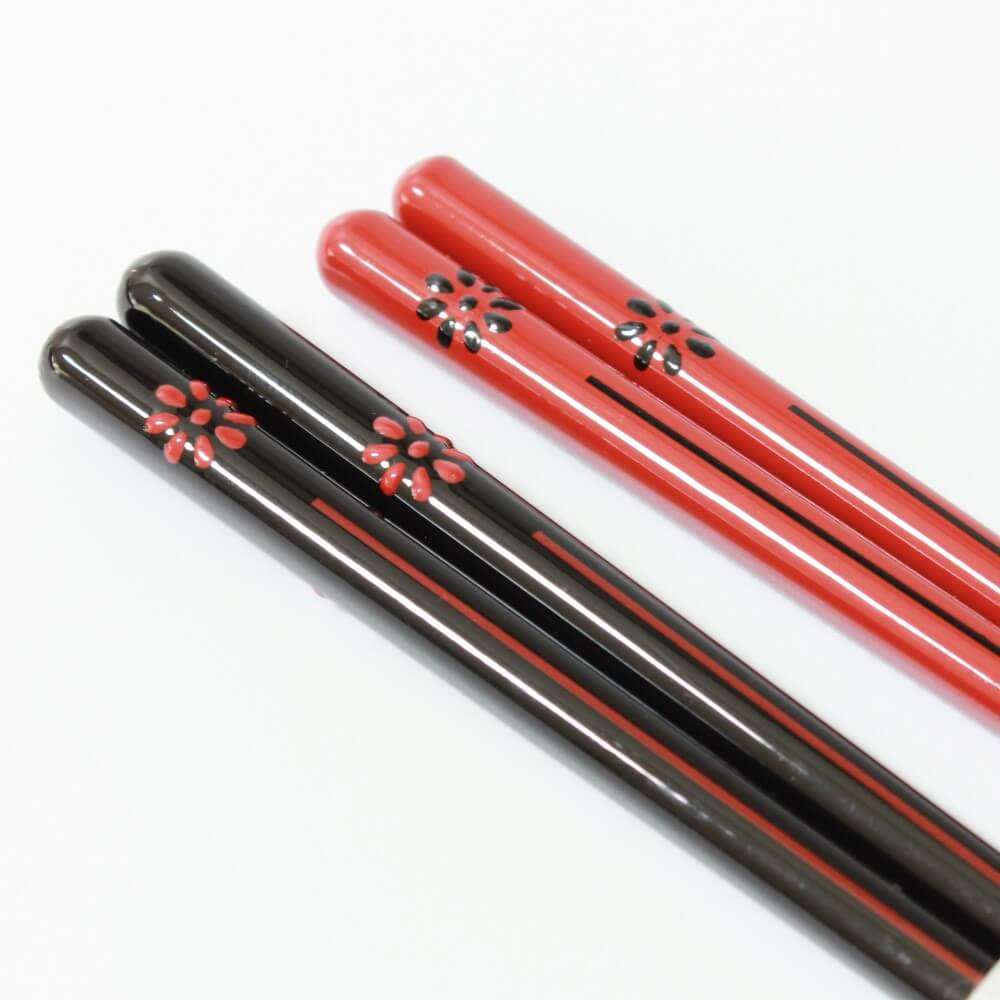 close up of handles of kikukomon chopsticks black and red