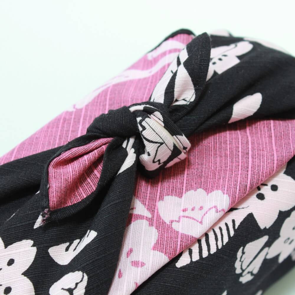 close up of knot of sakura charcoal black pink furoshiki