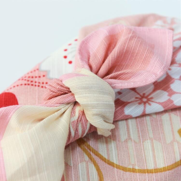 close up knot tied pink furoshiki with sakura flowers