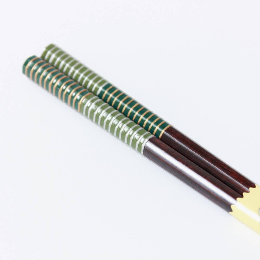 close up musou green chopsticks handles diagonal position