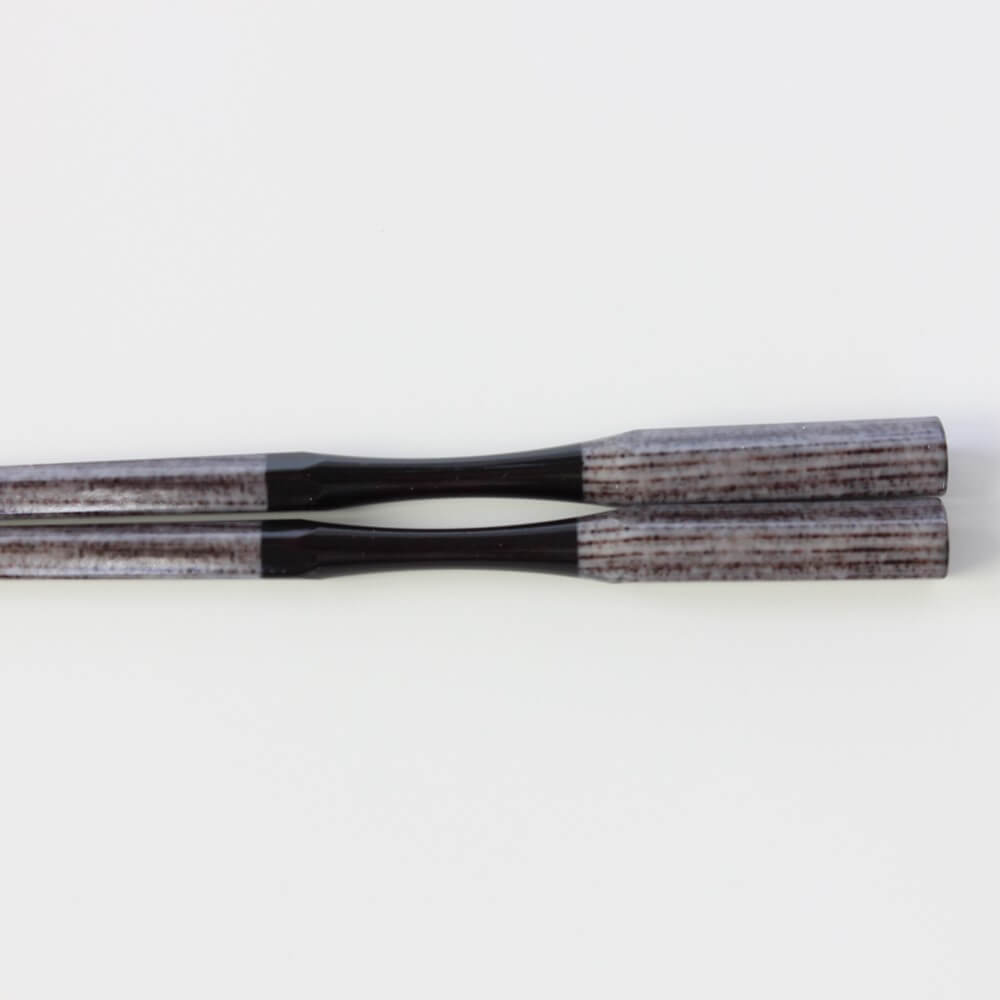 close up of curved neck antique grey chopsticks