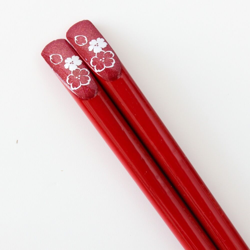close up red chopsticks with red background cosmos pattern