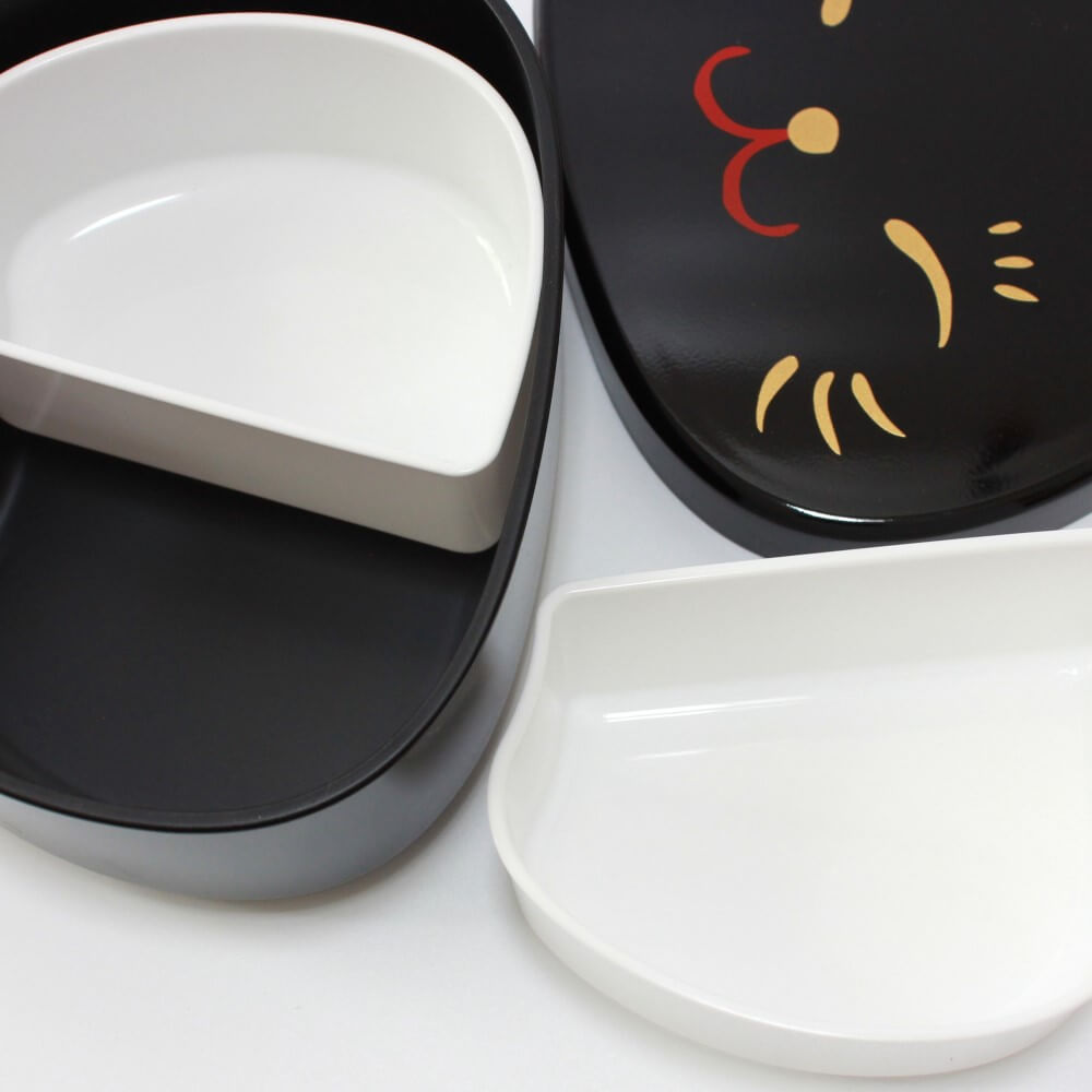 close up shot black maneki cat bento box