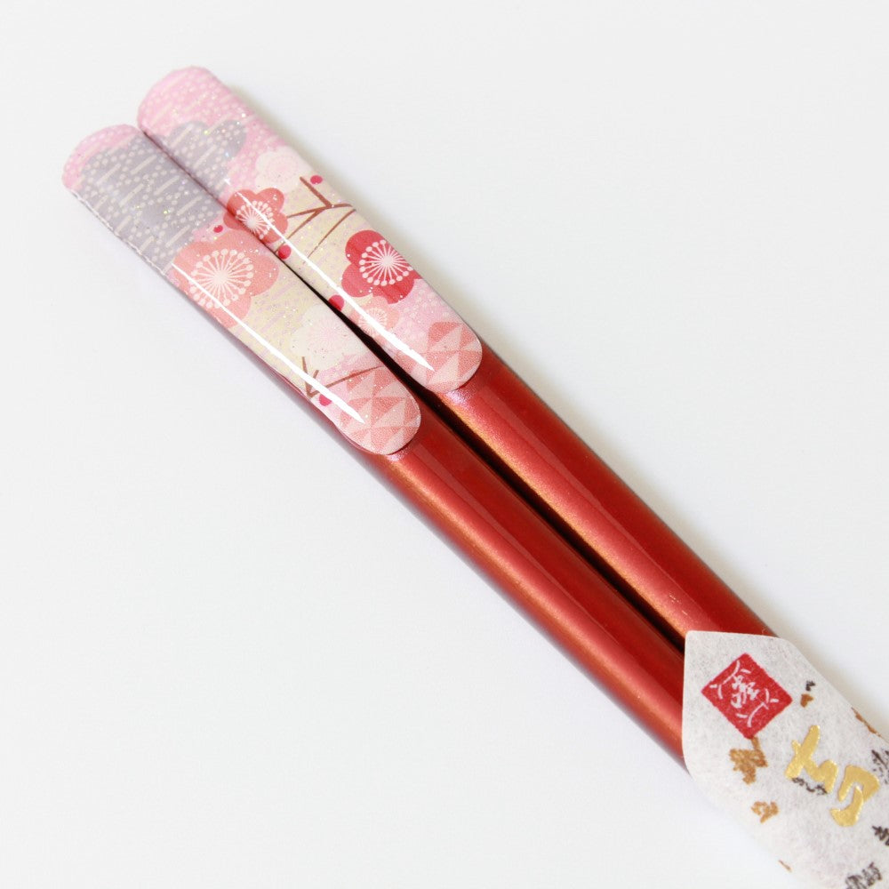 close up showing fukuju red handles with plum flower design