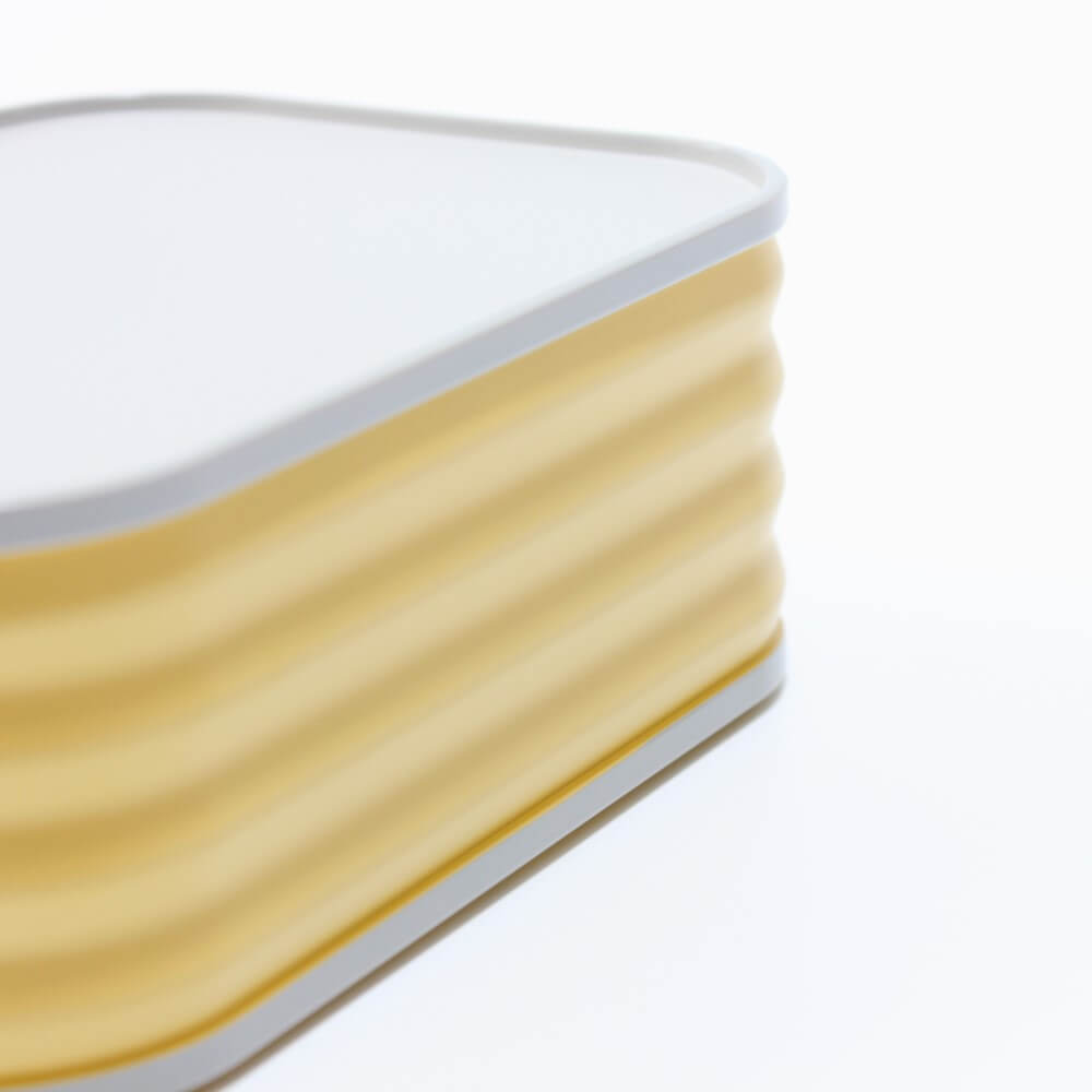 close up of side of yellow eatcan bento box
