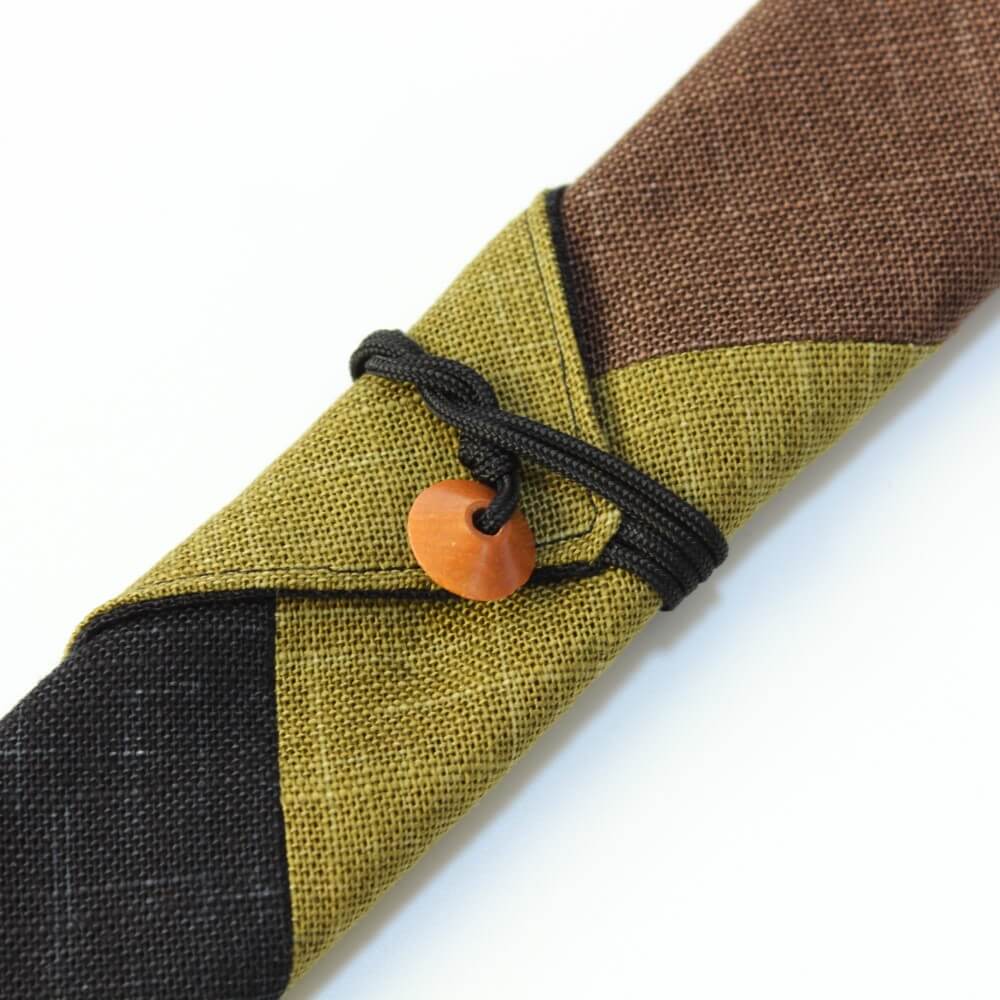 close up of soroban bead and string that's securing chopsticks wrap