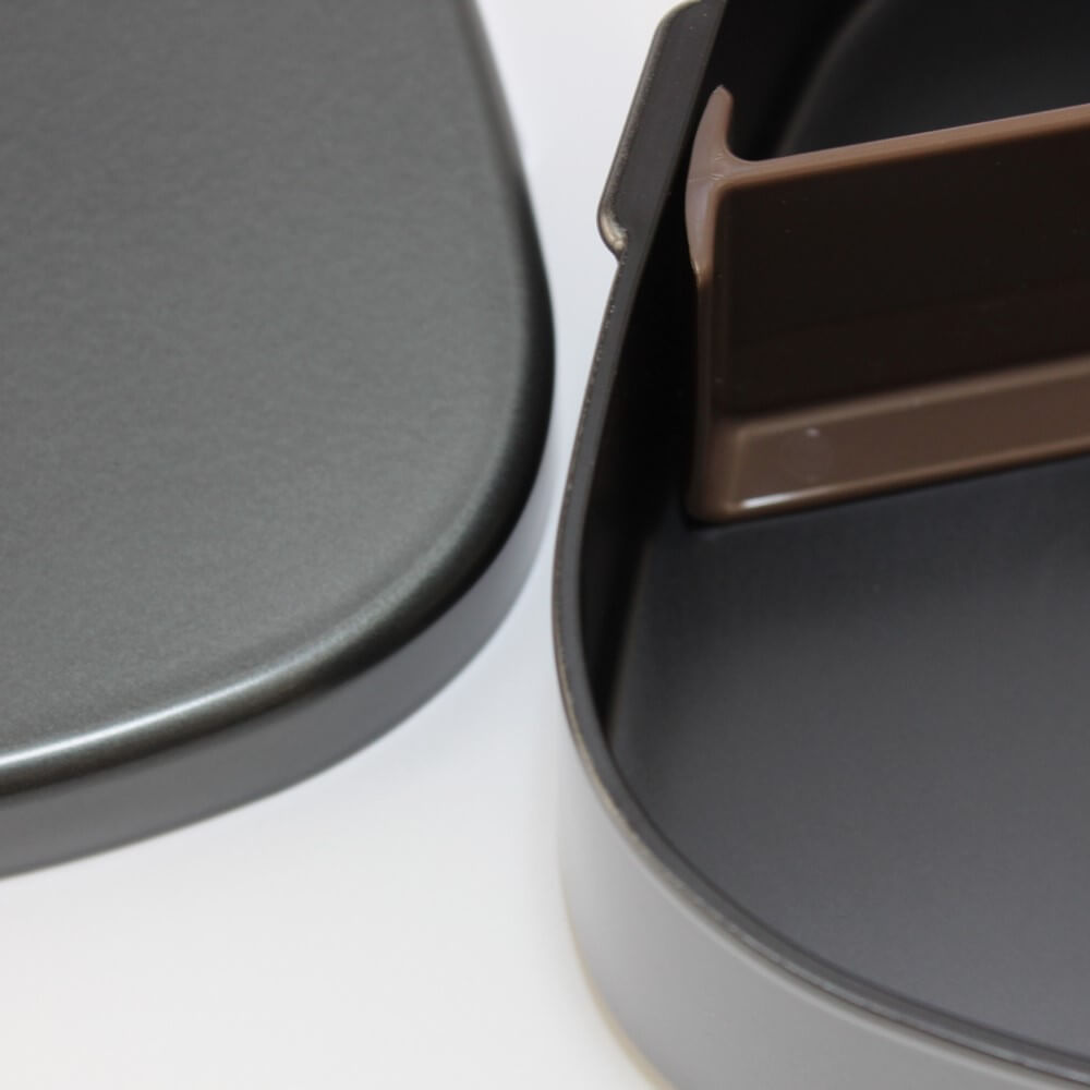 close up surface metallic black bento box one touch