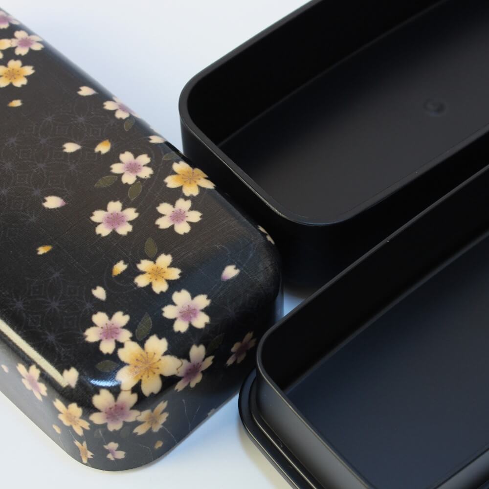 close up surfaces bento box with sakura flowers