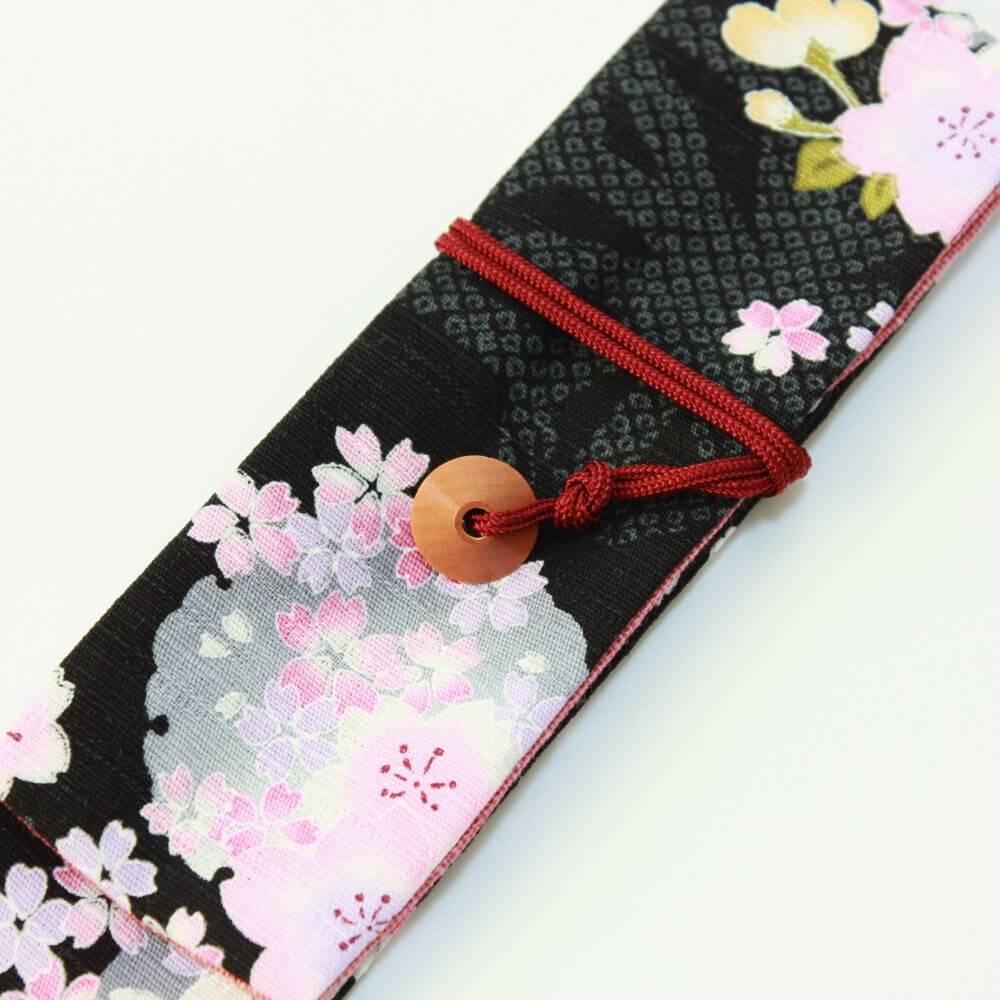 closeup of sakura blossom black chopsticks case