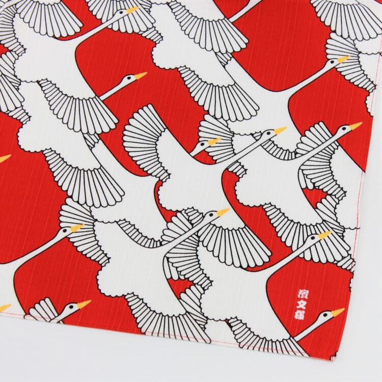corner shot of red hama monyo celebration crane japanese wrapping cloth showing the beautiful cranes