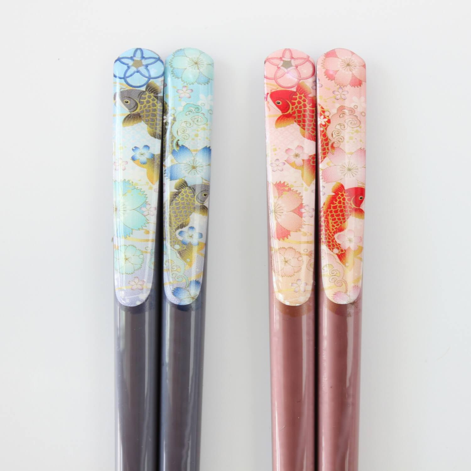 close up of chopsticks handles showing koi carp fish artwork