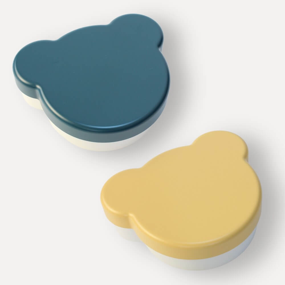 Two bear-shaped containers, one blue and one yellow, on a white background