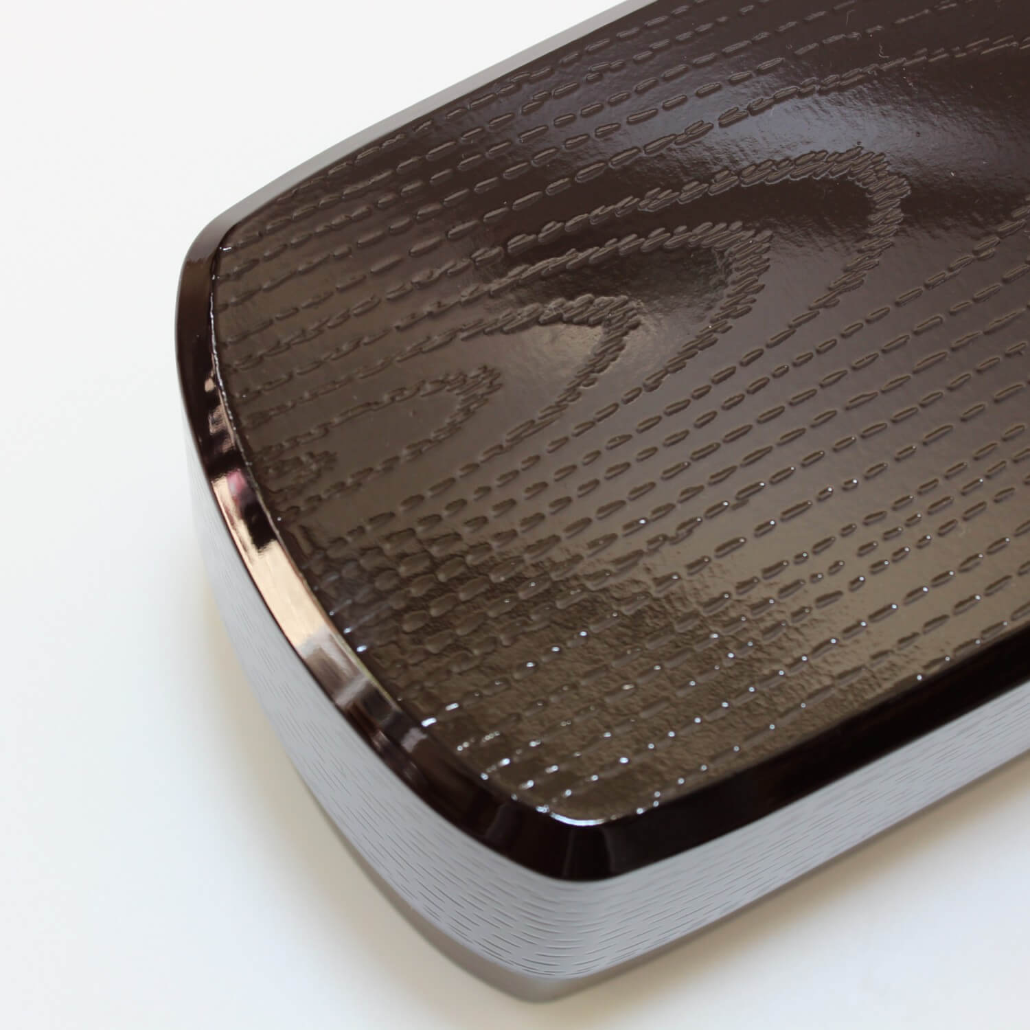 close up of lid of tame mokume bento box showing textured surface like wood