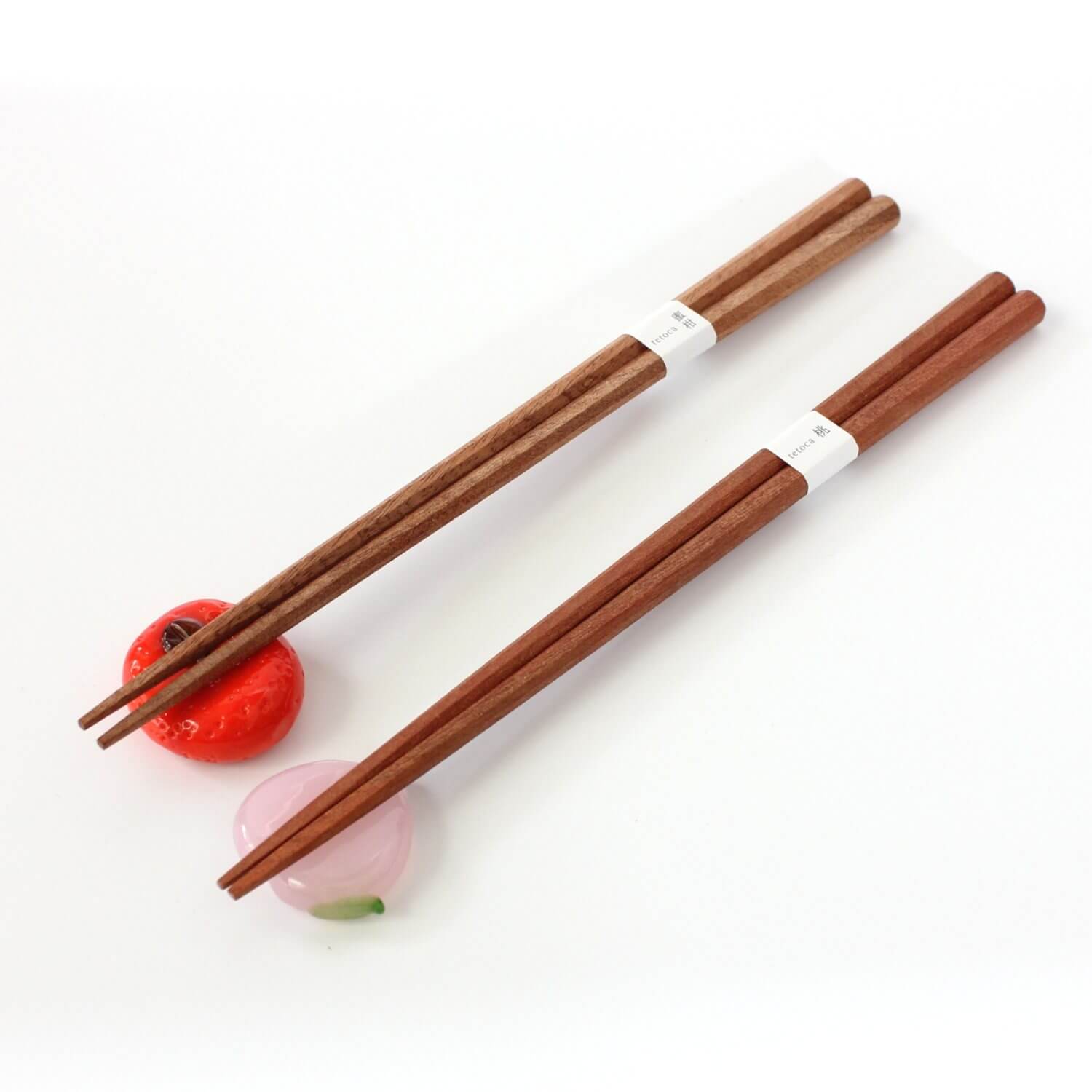 mandarin and peach wood chopsticks on rests