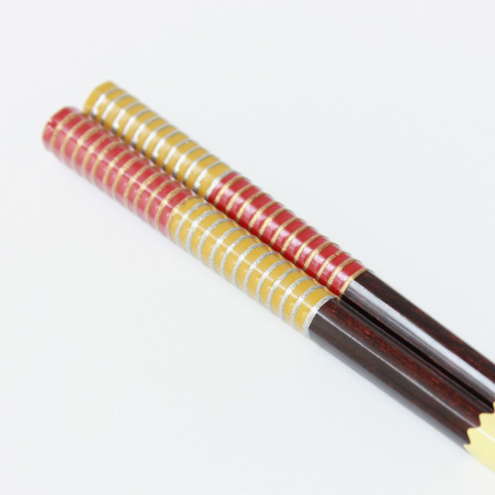 musou red wood chopsticks close up handles from diagonal angle