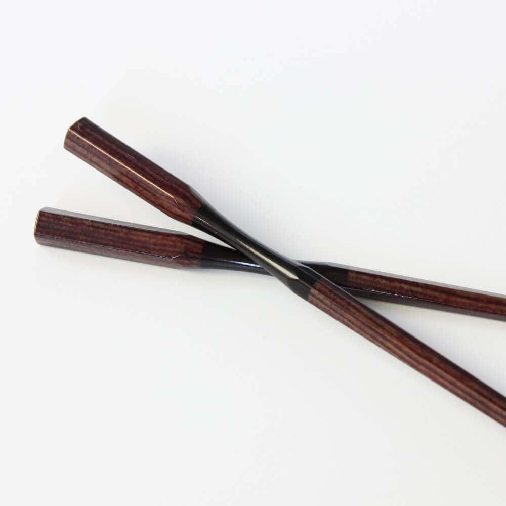 one chopstick sitting on its pair 