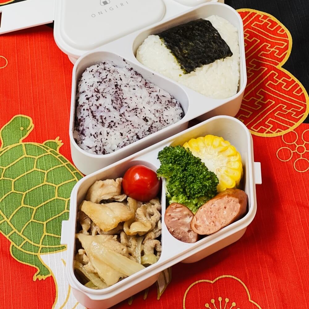 onigiri bento in a white 2 tiered bento case and mould