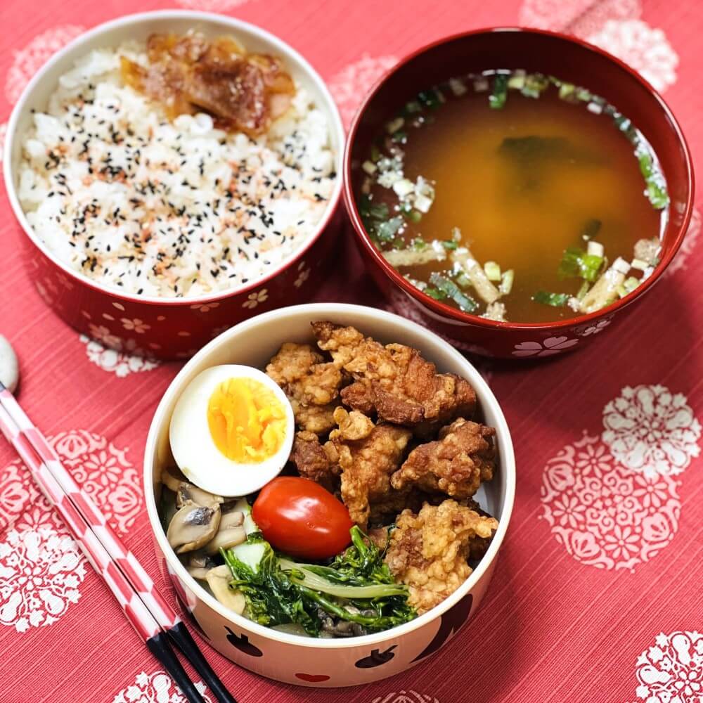 overhead photo kokeshi hanako bento box with food