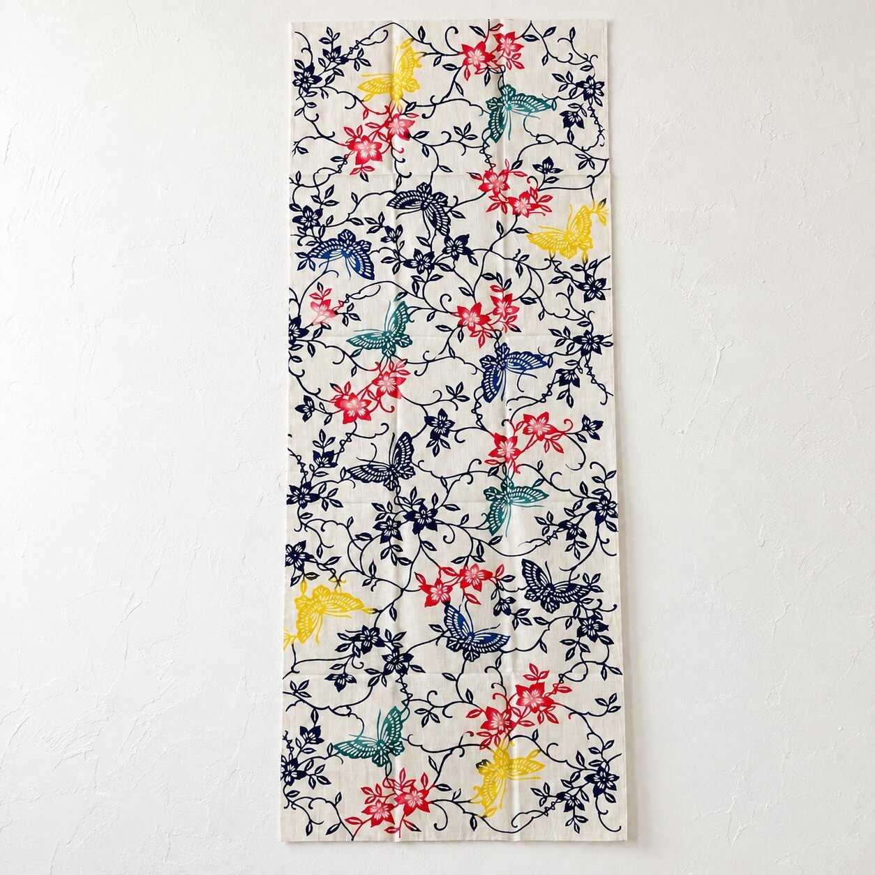 clematis and butterflies tenugui pattern on a white wall