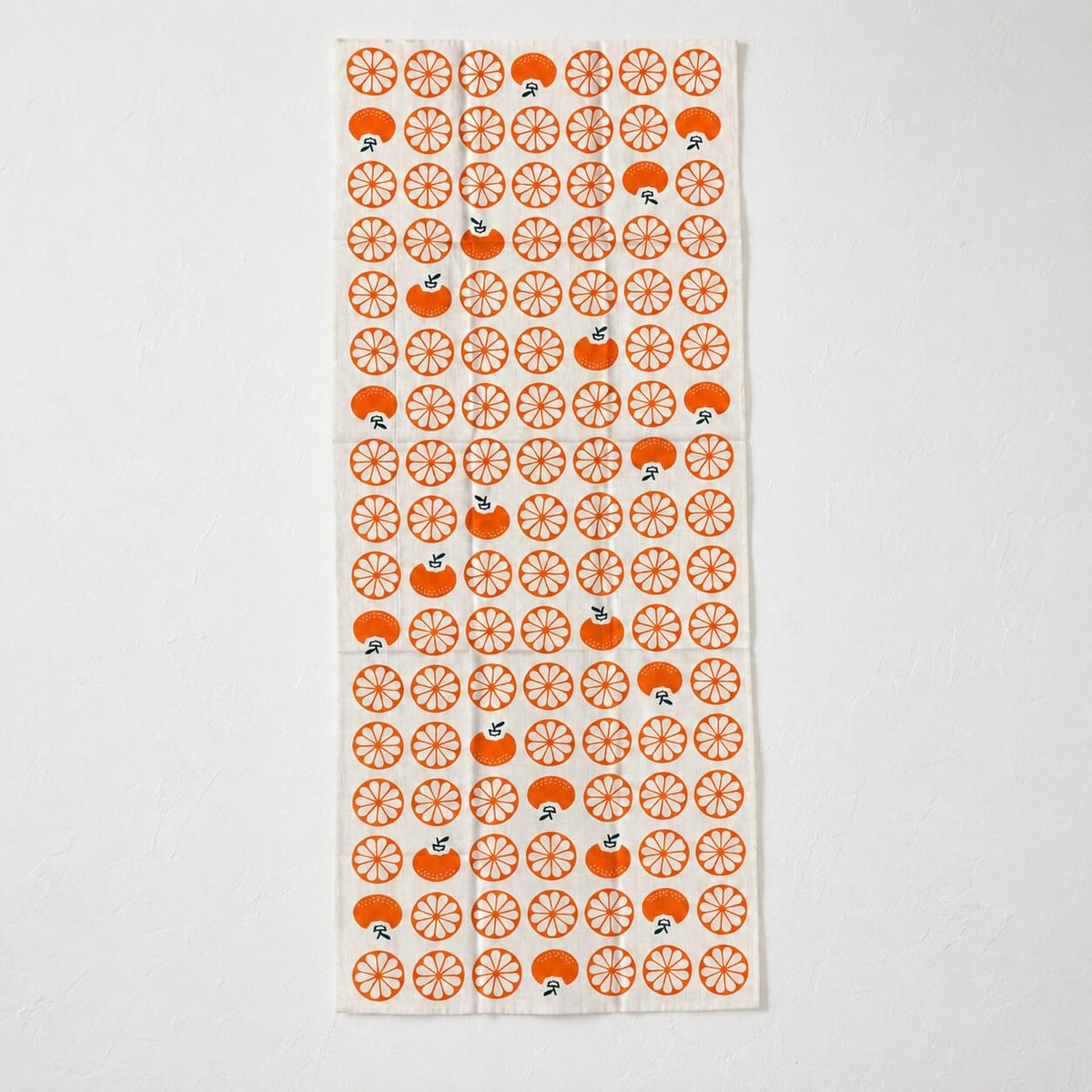 tenugui with japanese mandarin patterns laid flat on a white background