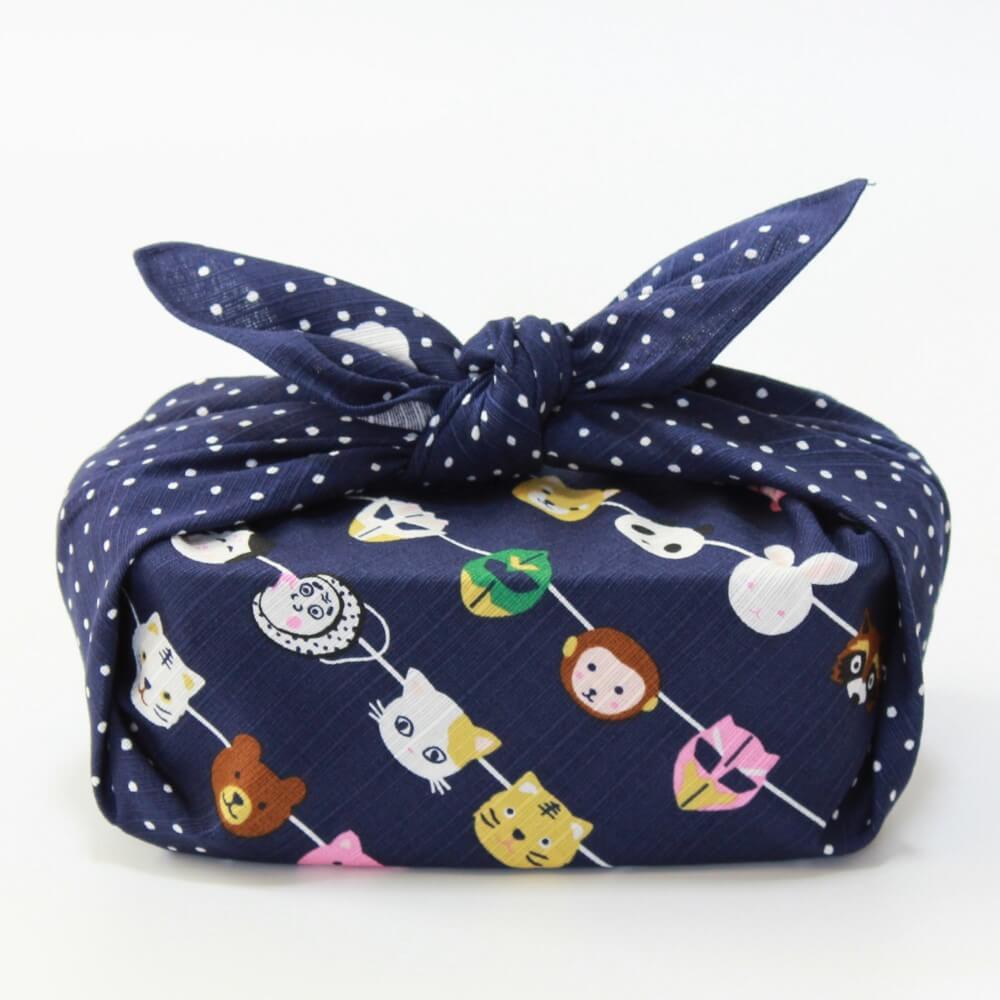 side profile bento box wrapped in japanese masks design furoshiki